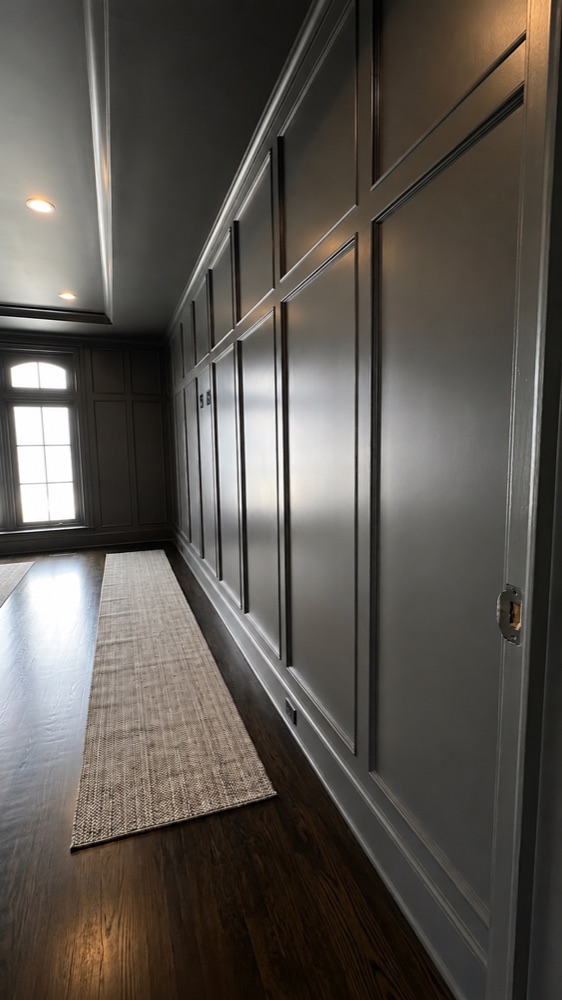 Hallway with painted gray wall paneling